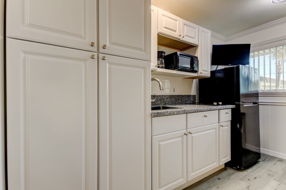 Kitchen with Full Fridge, Cooktop, Microwave, Coffee Pot & Toaster