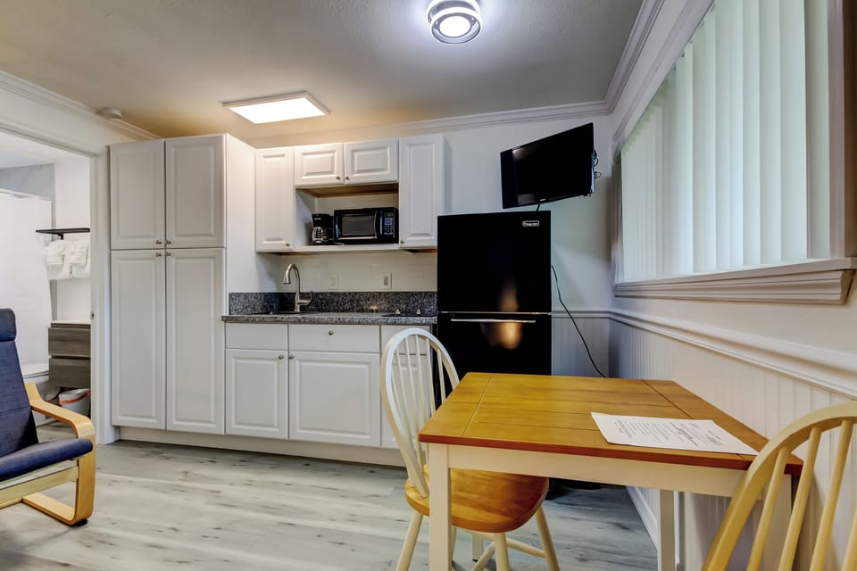 Kitchen with Full Fridge, Cooktop, Microwave, Coffee Pot & Toaster