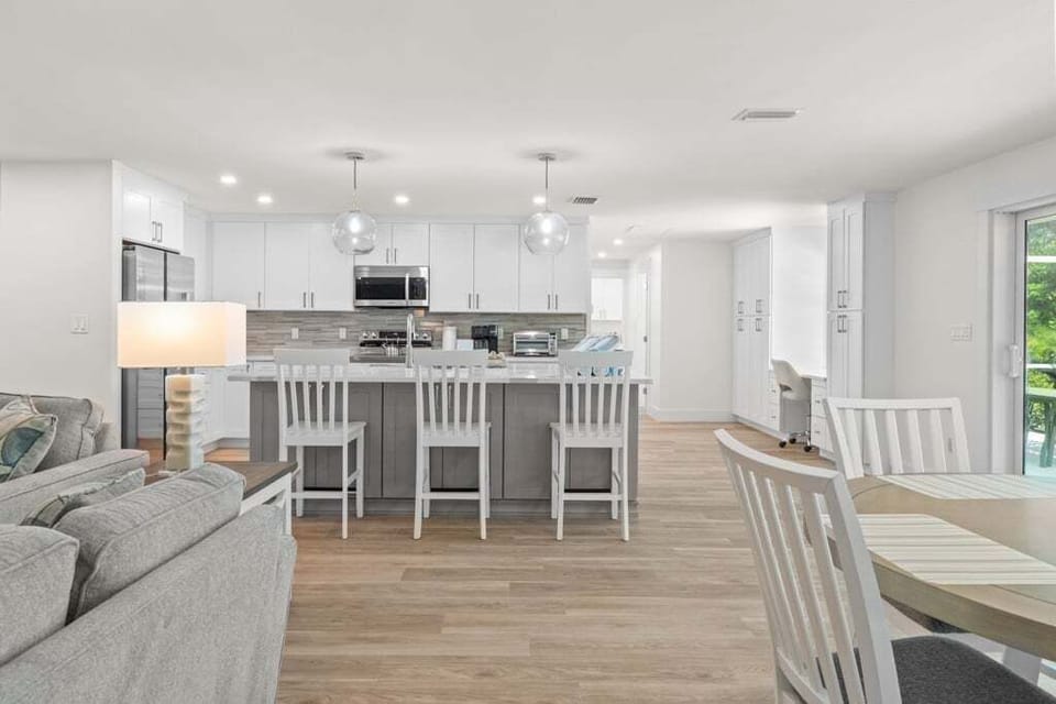 Spacious open-concept kitchen, dining, and living area designed for seamless entertaining and family gatherings