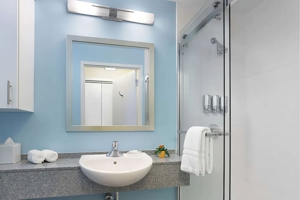 Refresh easily in a spotless bath with bright vanity lighting