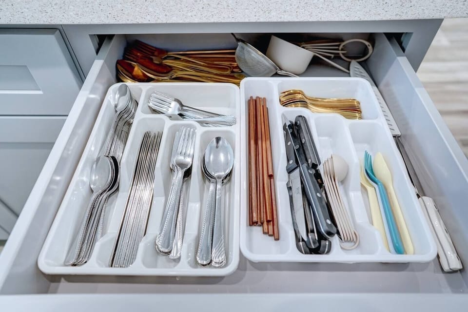 Kitchen drawer neatly stocked with cutlery, chopsticks, and essential utensils.