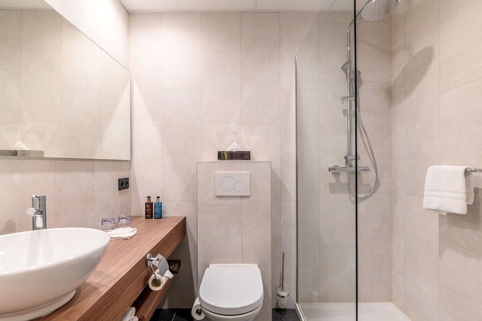 Refresh under a glass walk-in shower in a spotless bath.