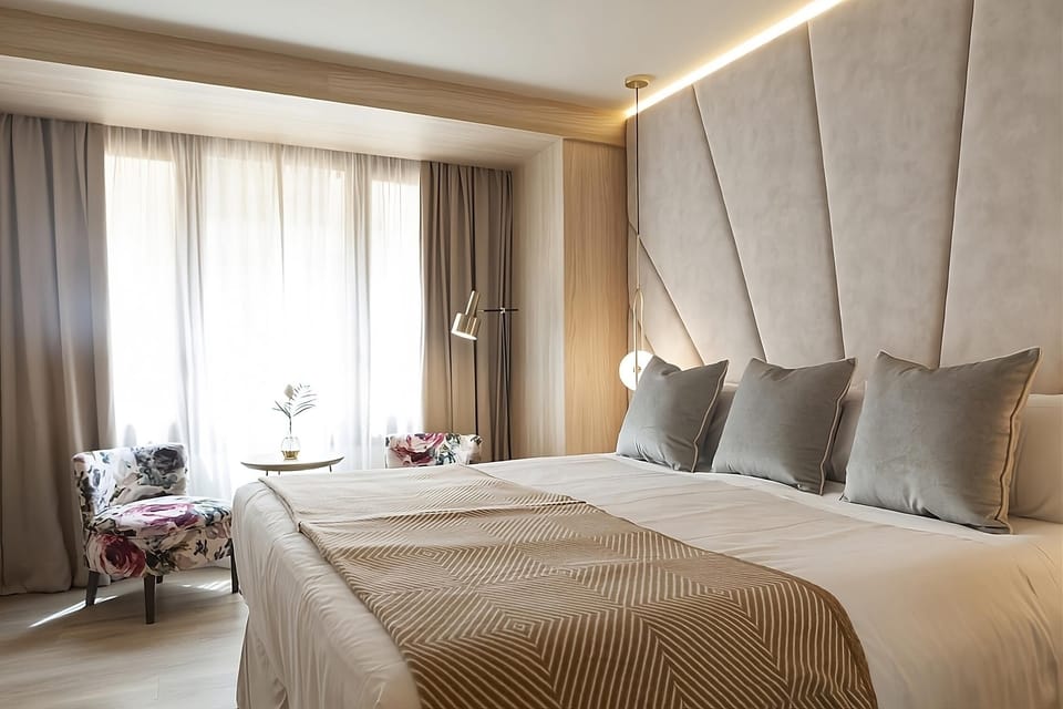 Wake refreshed in a sunlit room with luxe, layered linens.
