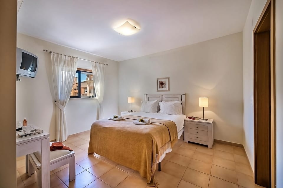Recharge in a cozy double room with warm, restful tones.