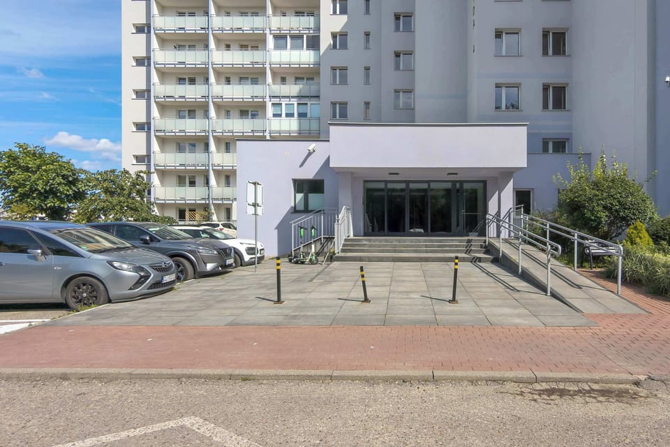 A spacious parking area in front of the building makes arrival convenient whether by car or taxi.