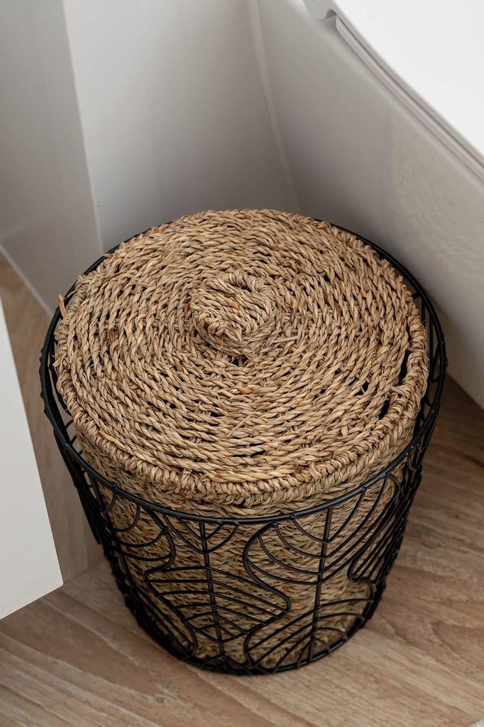 The woven basket in the bathroom corner adds a natural touch and serves as a practical spot for laundry or towels.