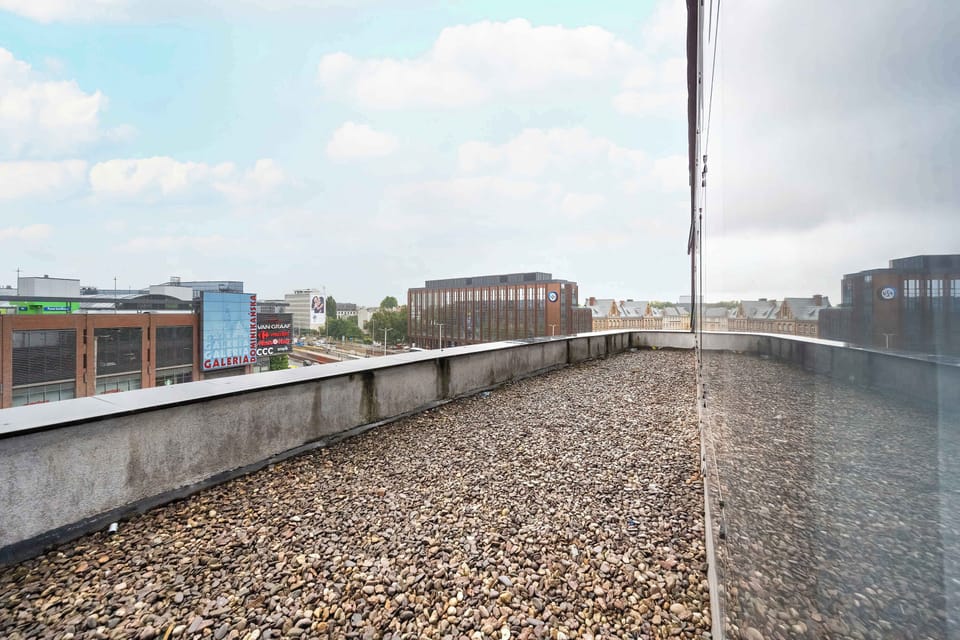 The spacious rooftop terrace offers a view of the city skyline and extra open-air space.