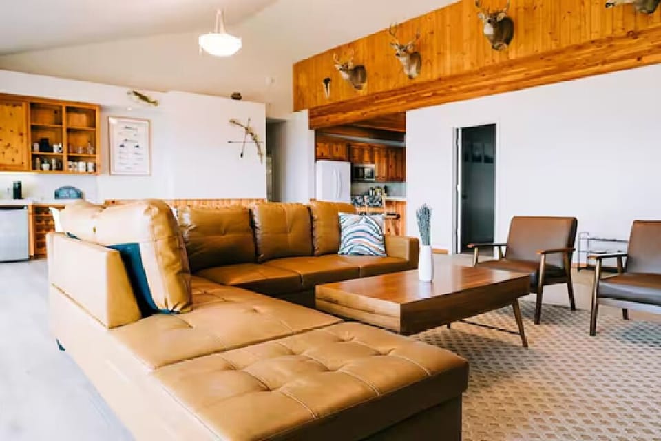 Cozy and relaxing living area with sectional couch and chairs.
