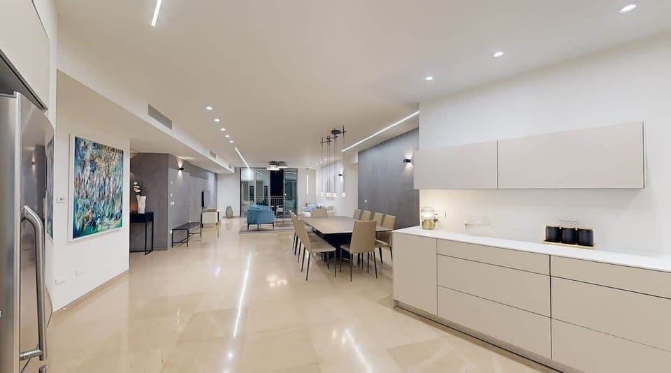 A modern kitchen and dining space seamlessly blending functionality and style. With sleek cabinetry, ample counter space, and an open layout leading into the living area, this space is ideal for both cooking and entertaining.