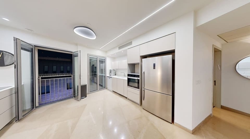 Bright and functional, this kitchen combines style and convenience with open access to the dining area and balcony, creating a seamless flow for entertaining and everyday use.