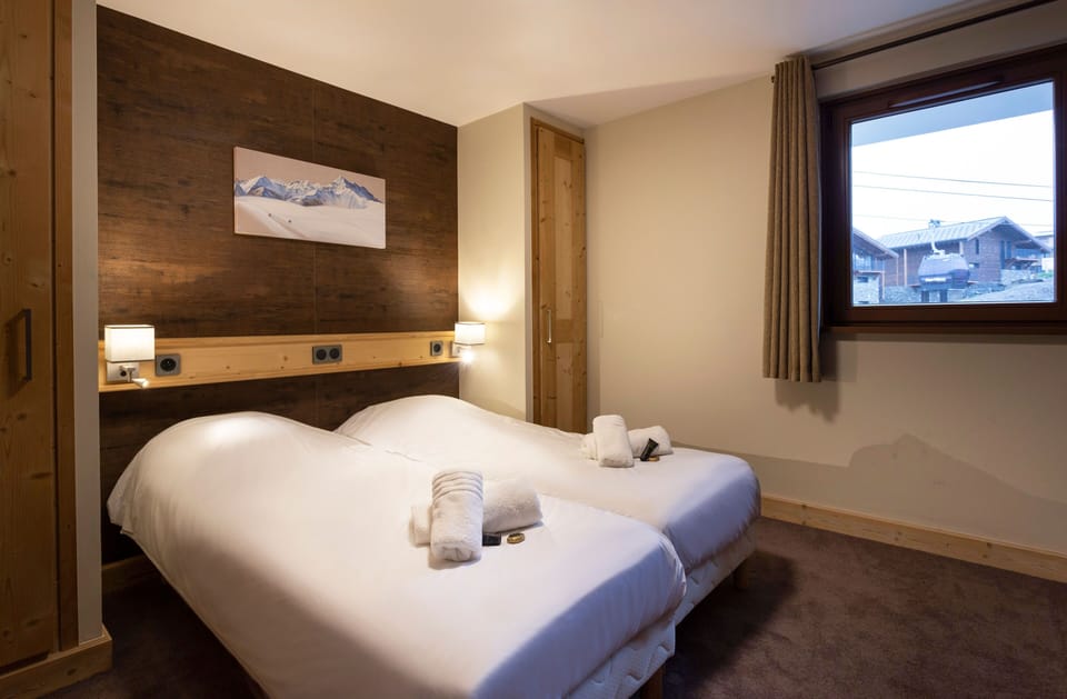 Spacious master suite featuring cozy lighting, soft linens, and natural textures for restful nights.