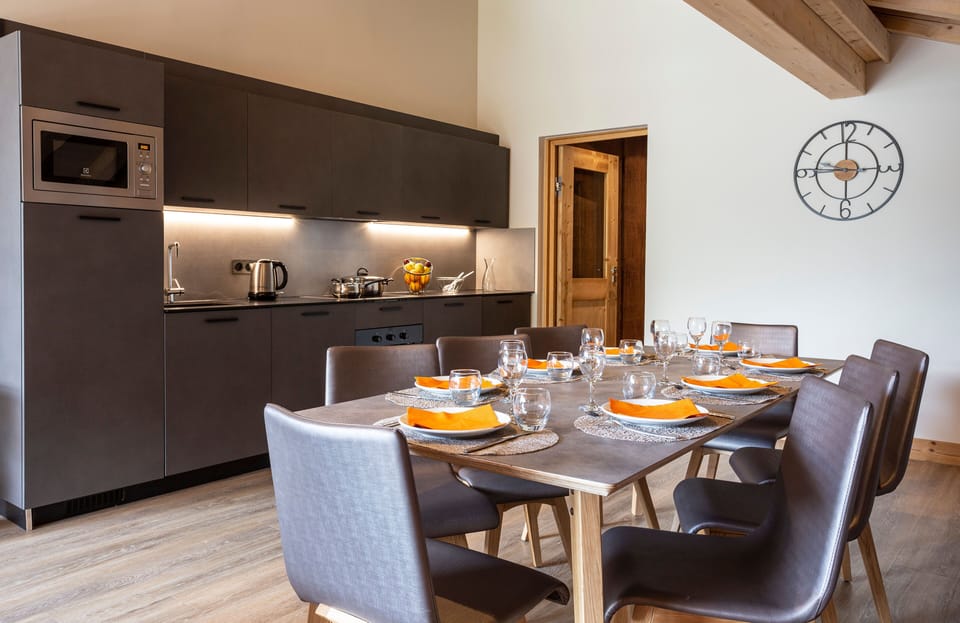 Spacious dining area with elegant place settings, perfect for entertaining.