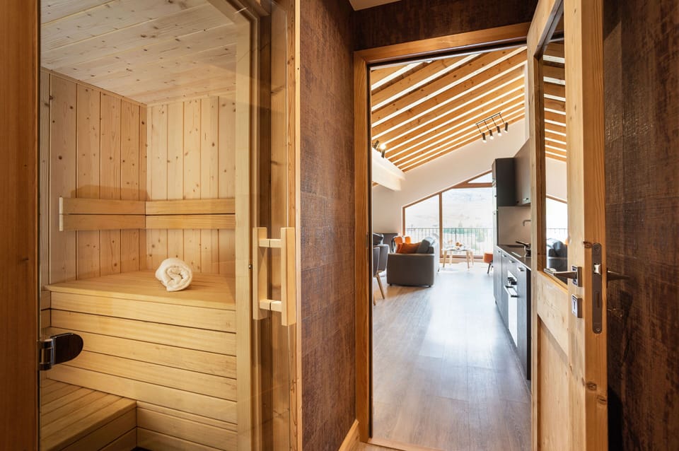 Warm wood-panelled sauna offering a serene space to unwind after a day in the mountains.