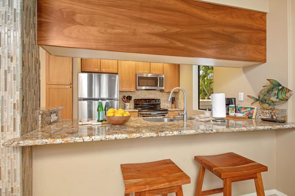 Bright kitchen with breakfast bar and wood cabinetry GCH-181