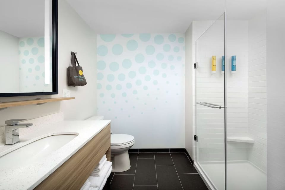 Reset with a sleek glass shower and bright, modern bathroom.