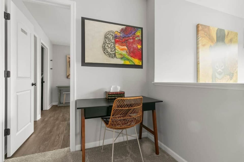 Quiet dedicated workspace with desk and natural light for remote work during your South Haven getaway.