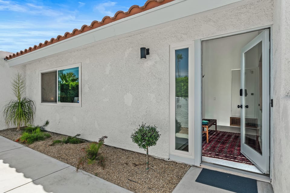 Private front entry with lush landscaping & quiet setting