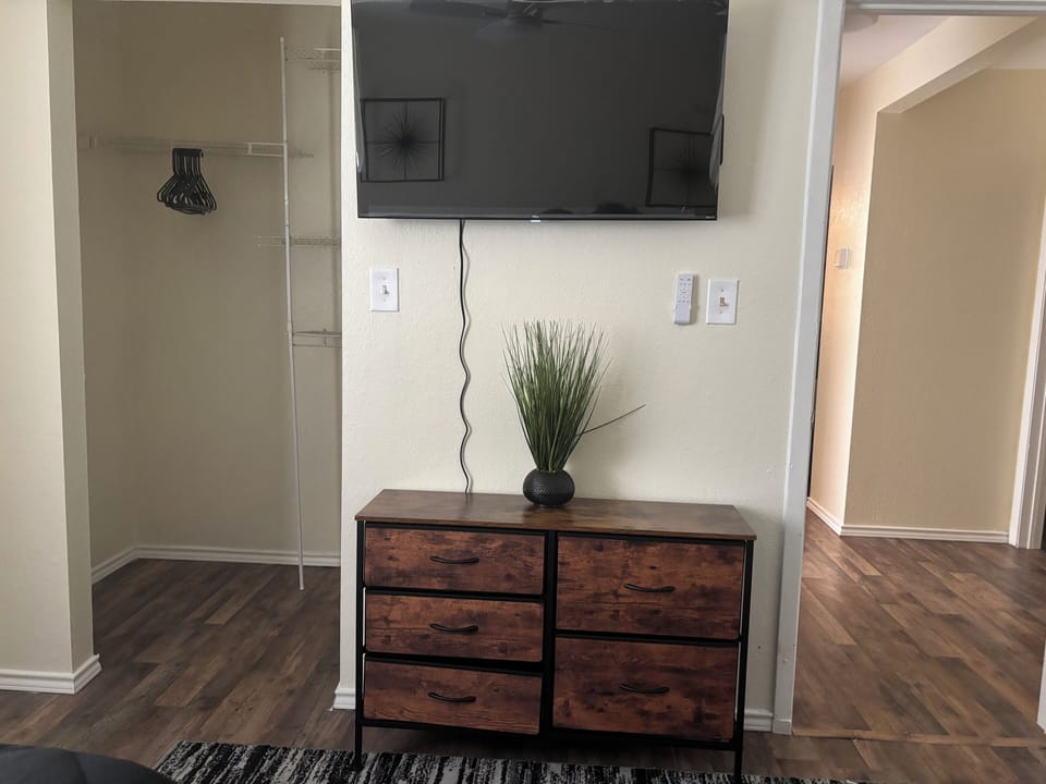 Room 1: Tv and dresser with 2 full beds