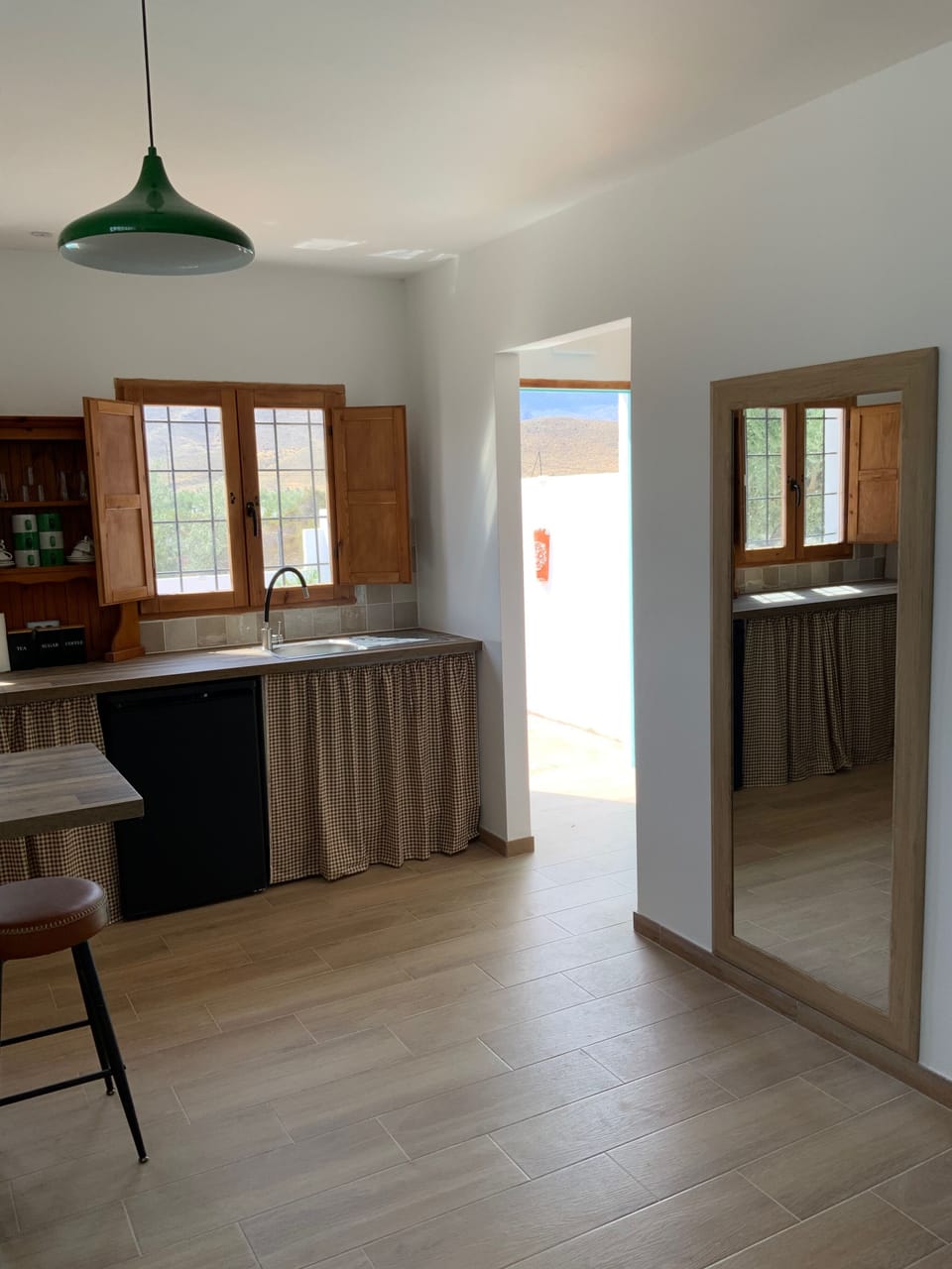 Kitchen to hall area with access to bathroom and main entrance door to garden. 
