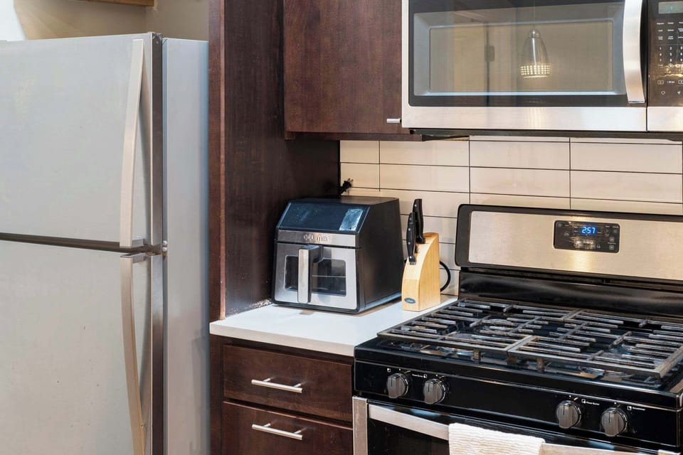 Kitchen setup w/ stainless appliances for simple cooking