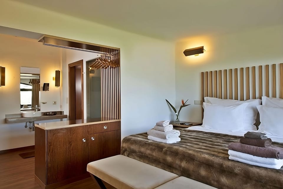Settle in with airy space, sleek vanity, and plush throws.