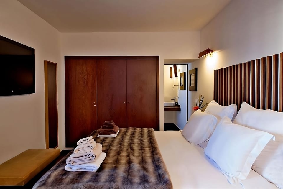 Unwind into crisp linens and warm, modern wood accents.
