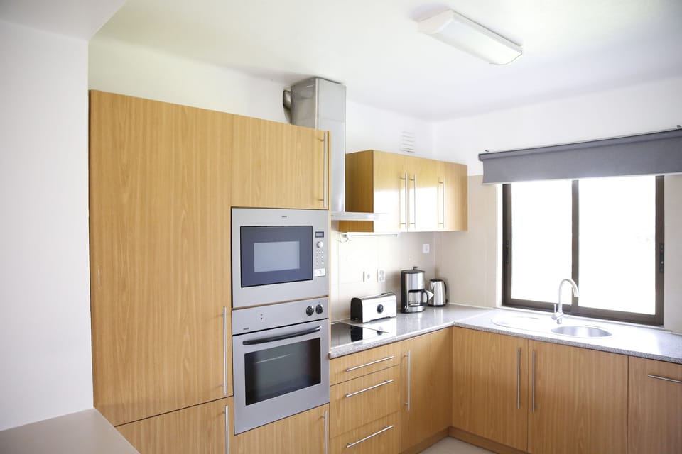 Cook comfortably in a bright kitchen with modern built-ins.
