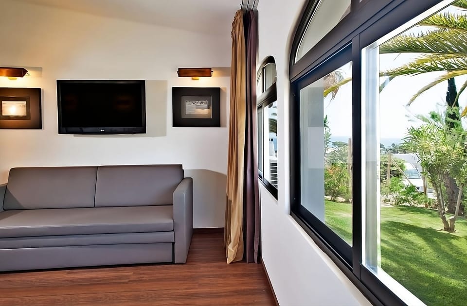 Kick back on the sofa and enjoy bright garden-side views.