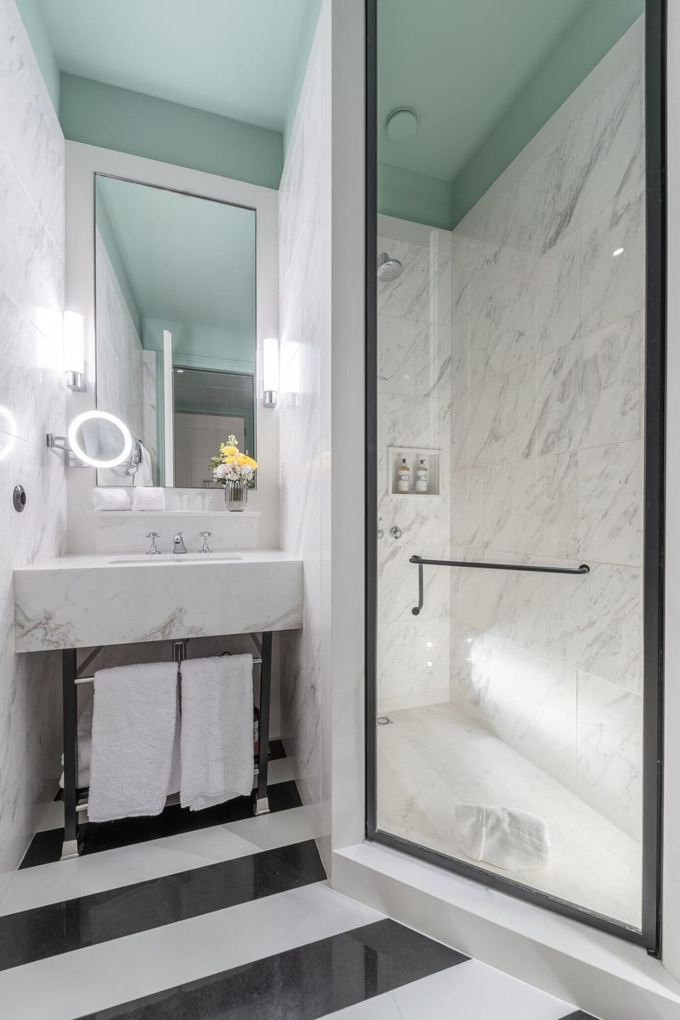 Refresh under a spa-like rainfall shower in marble serenity.