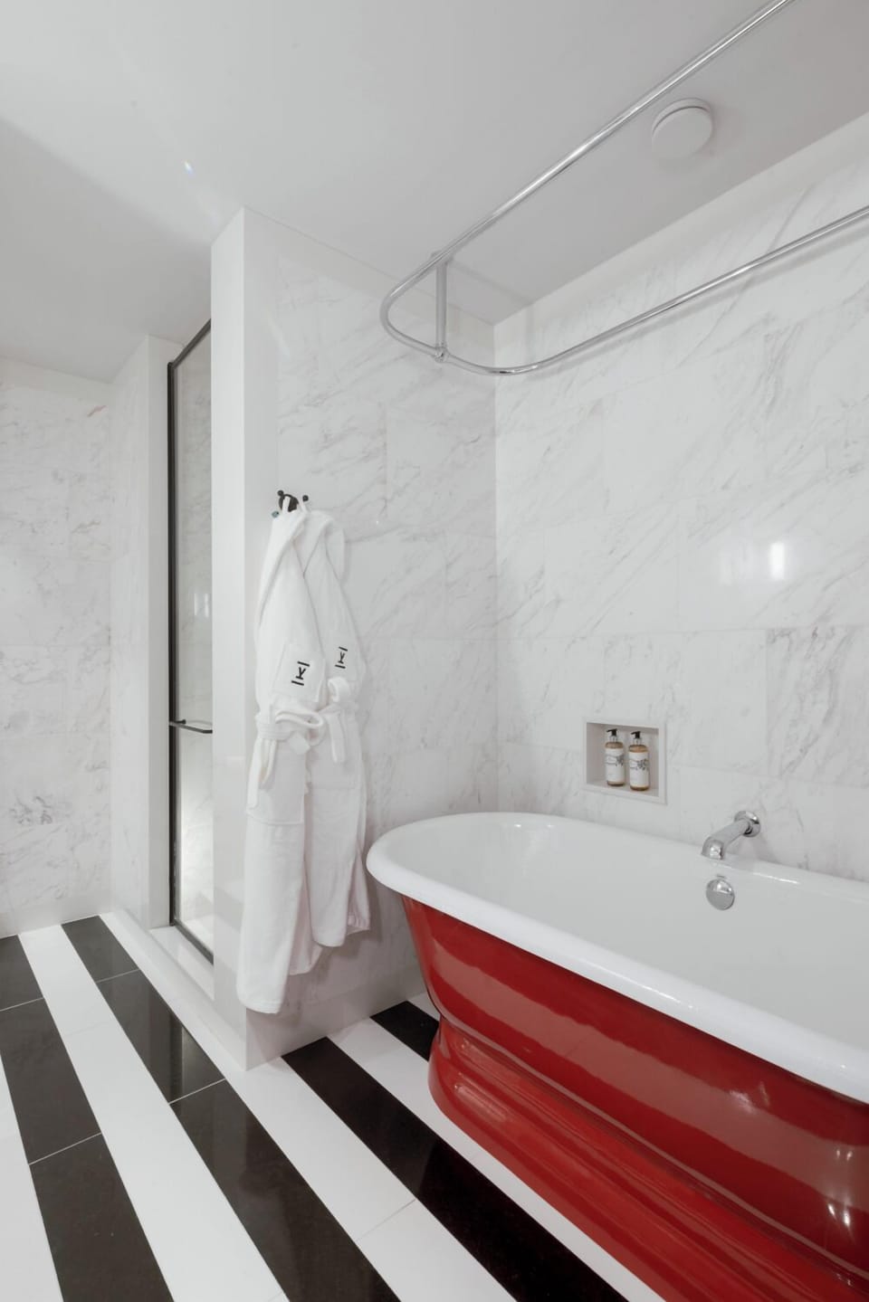 Refresh in a bright marble bathroom with a deep soaking tub.