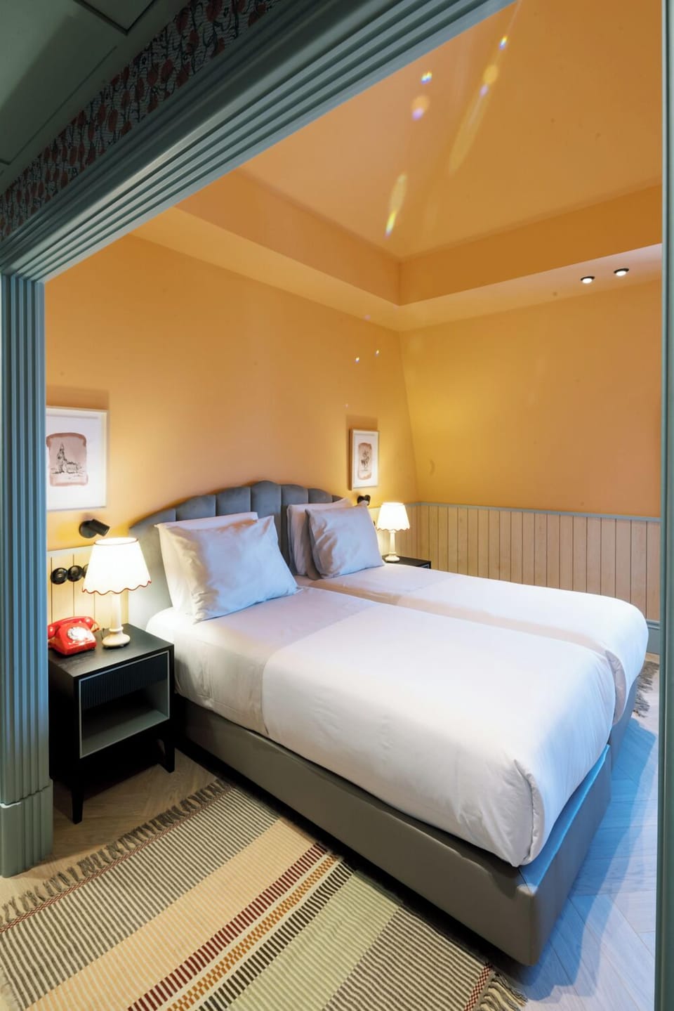 Drift off beneath glowing lamps in a cozy, tucked-away nook.