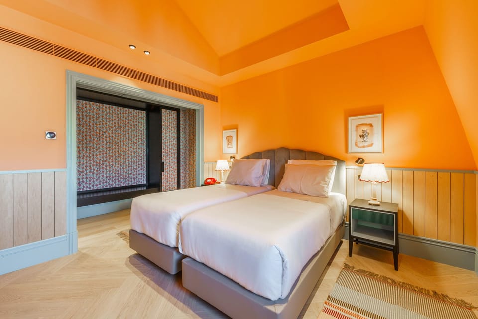 Sink into crisp linens in this warm, design-forward bedroom.