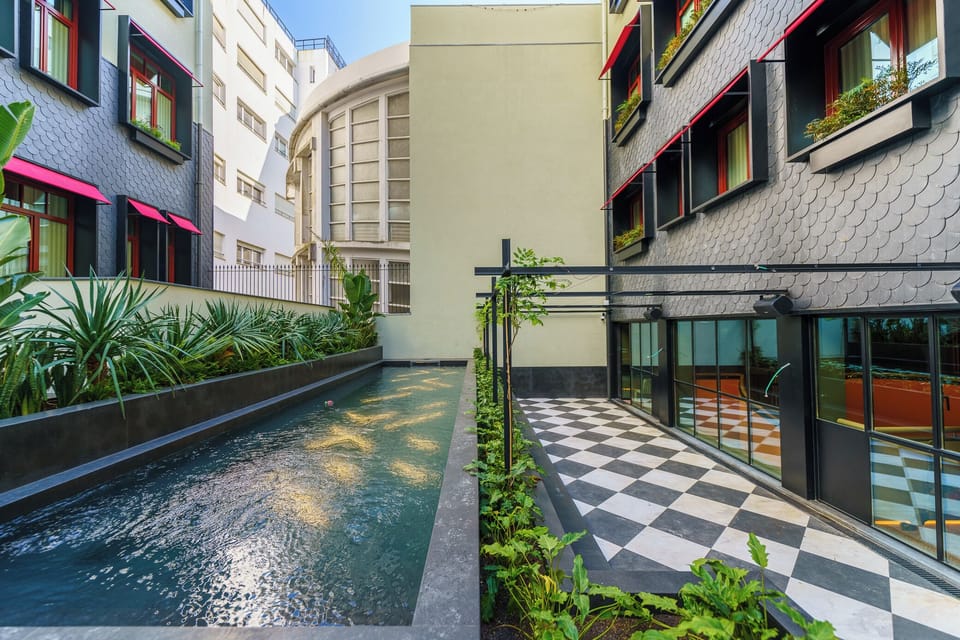 Unwind beside the sleek courtyard pool in city serenity.