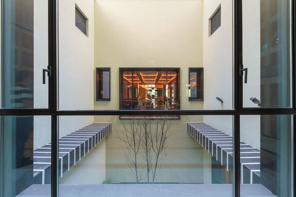 Pause in the tranquil courtyard framed by modern geometry.