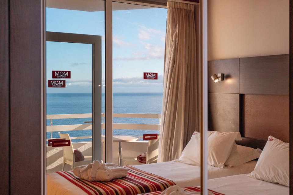 Drift off with the ocean horizon framed beside your bed.
