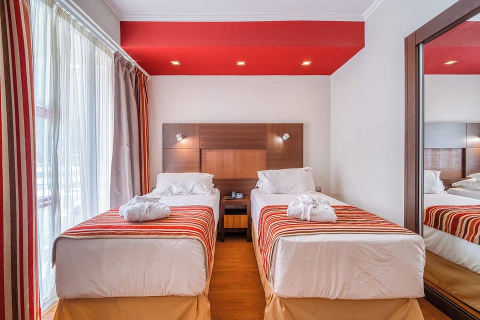 Drift off comfortably with airy curtains and hotel-fresh linens.