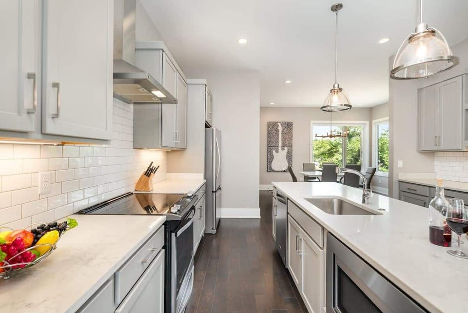 2nd Floor: Fully Equipped Kitchen with stainless steel appliances and a spacious island with seating for 4 guests.