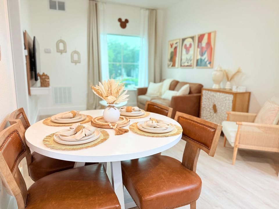 Gather around a cozy dining table that comfortably seats four.