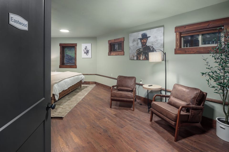Step into the Eastwood room, a themed king bedroom with seating area and Western-inspired art. A comfortable, stylish retreat in this Montana lodge near Glacier National Park.