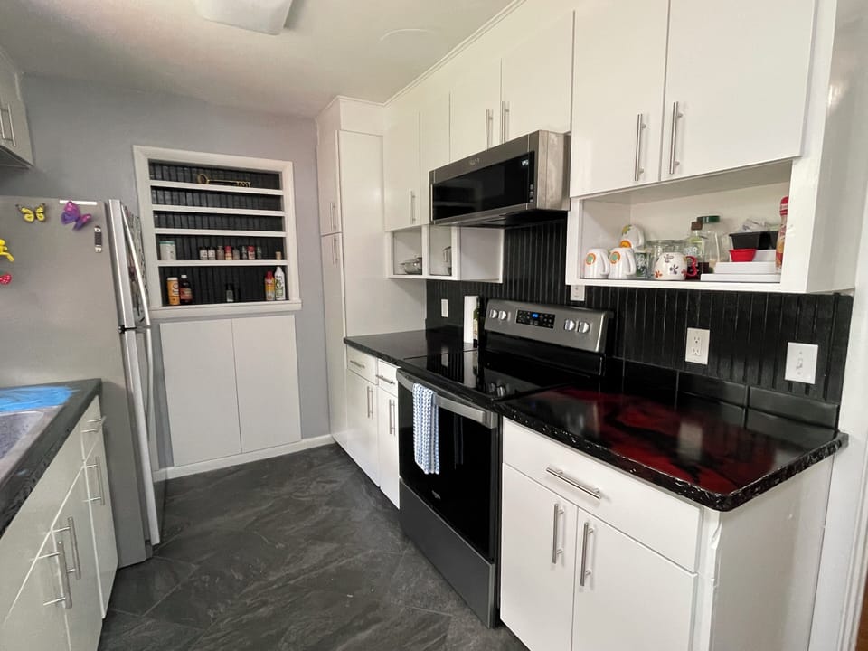 Built  in space for spices on the back wall, stove, oven, microwave