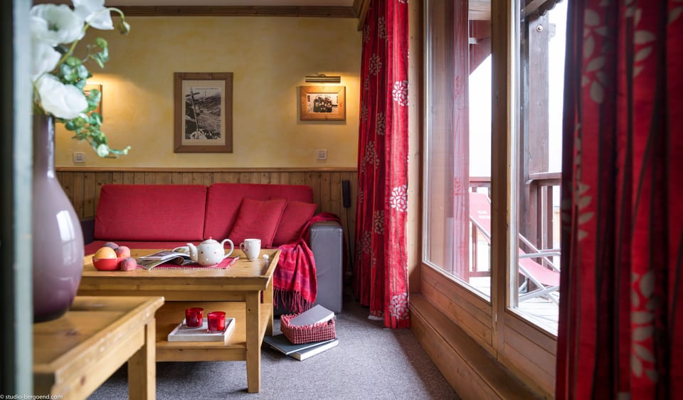 Twin bedroom with soft lighting and red accents, ideal for kids or friends sharing a stay.