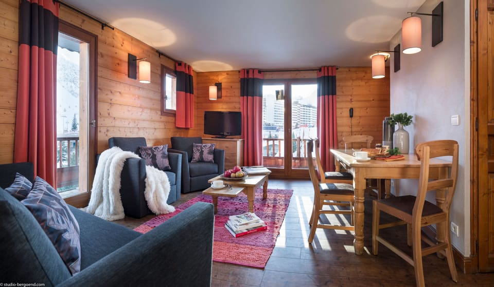 Open-concept lounge and dining area with access to the private balcony.