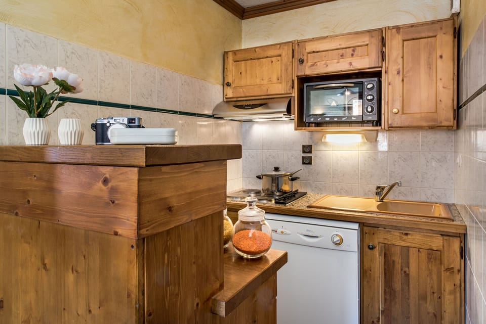 Fully equipped kitchenette with microwave, stove, and all essentials for easy mealtime prep.