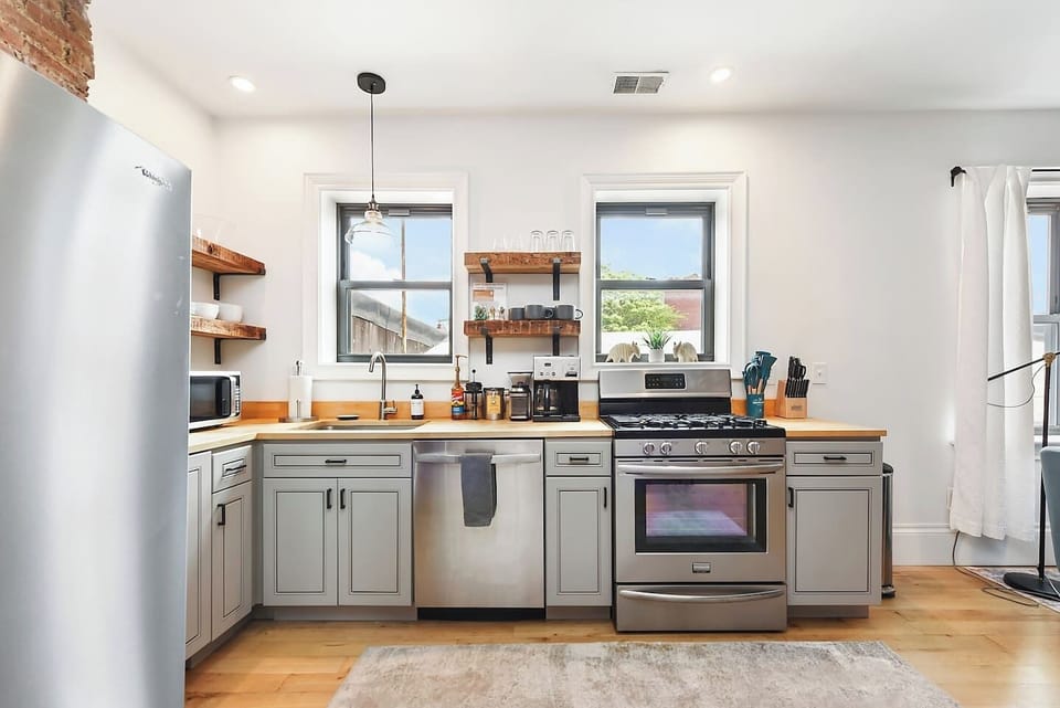 Fully equipped kitchen featuring modern design and sleek stainless steel appliances — ready for all your cooking needs.