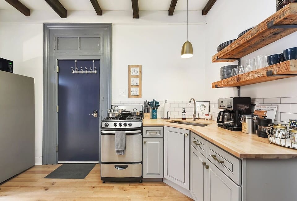 Fully equipped kitchen featuring modern design and sleek stainless steel appliances — ready for all your cooking needs.