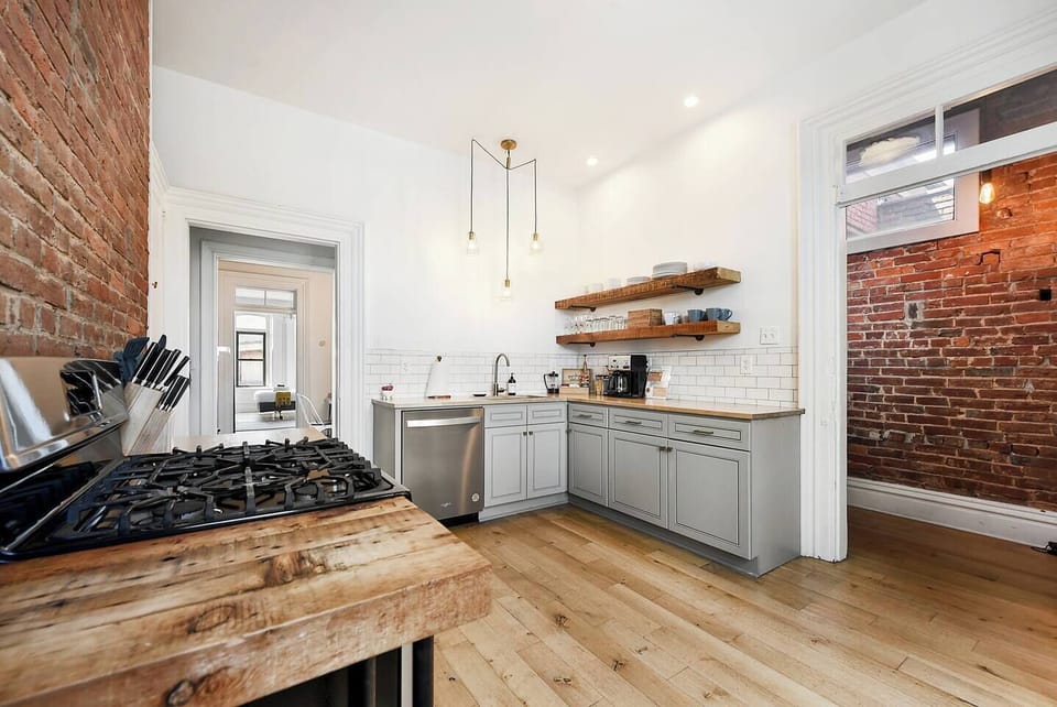 Fully equipped kitchen featuring modern design and sleek stainless steel appliances — ready for all your cooking needs.