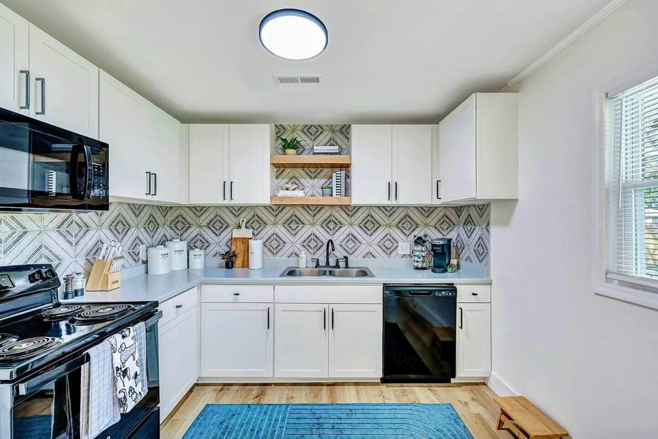 Newly renovated kitchen with Keurig, French press, cookware, and open-concept design.