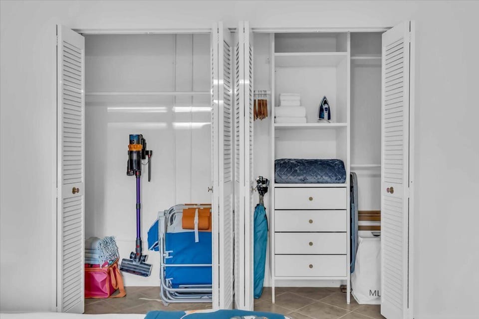 There's a large closet with built in shelving, racks, and drawers that provide lots of space for storing clothing and other items.