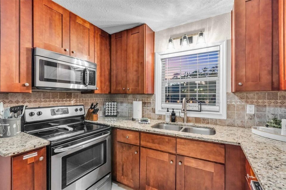 Beautiful modern kitchen with granite countertops and dark wood cabinets