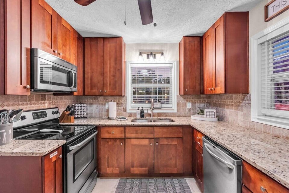 Stainless steel appliances including a microwave, stove top oven, toaster, & dishwasher